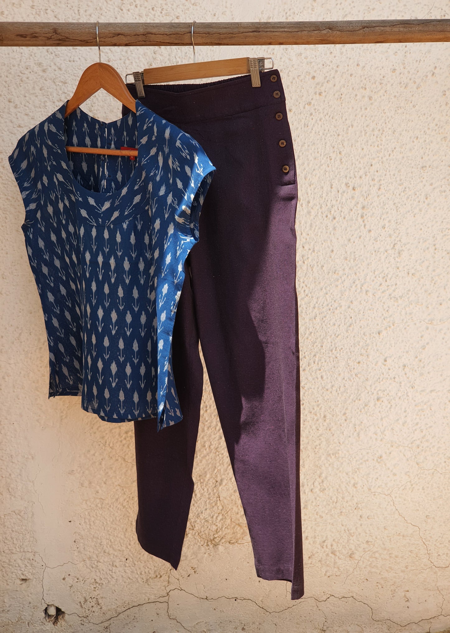 Picture of ink blue top with dark purple pants