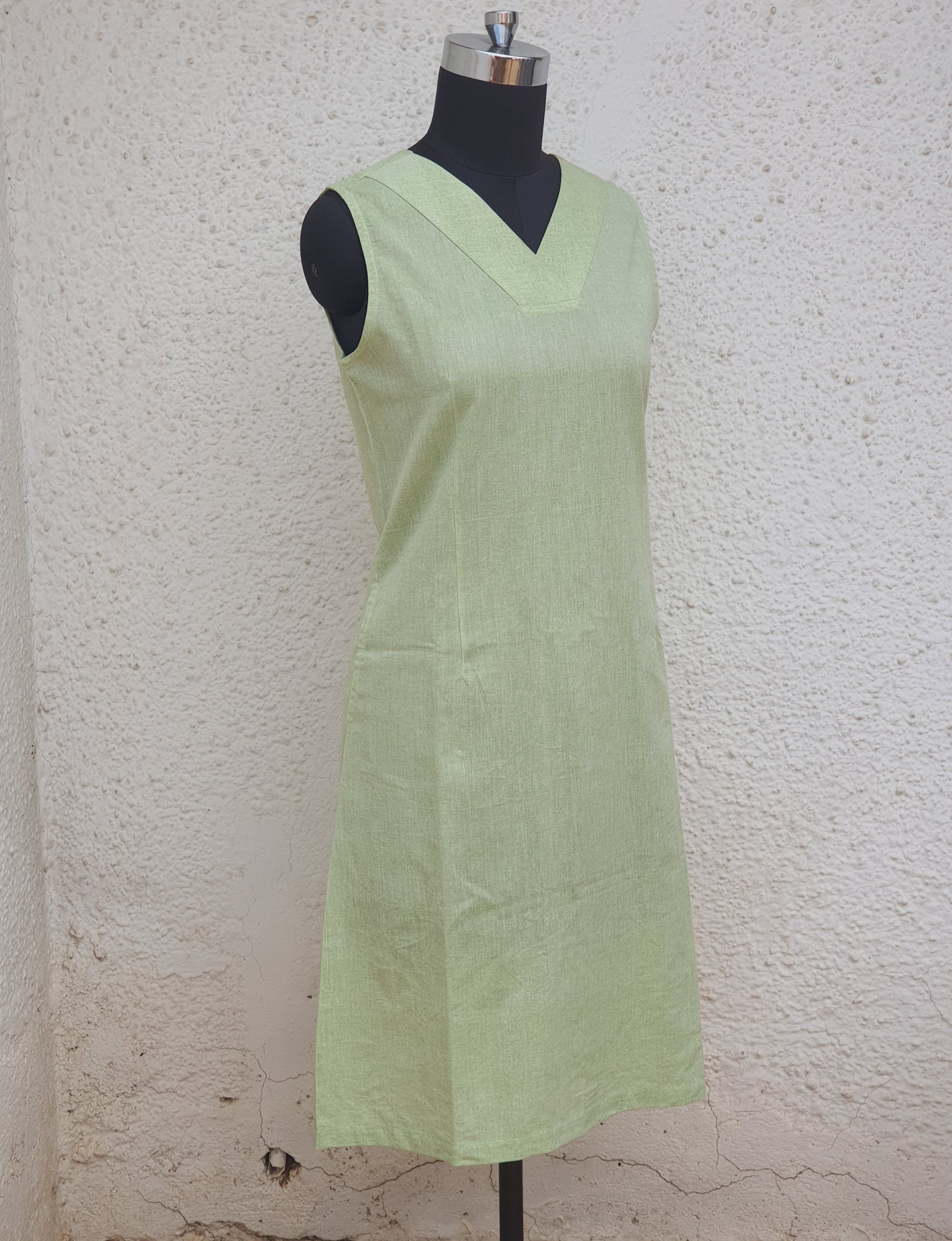 Picture of V necked dress in lime green cotton on a mannequin