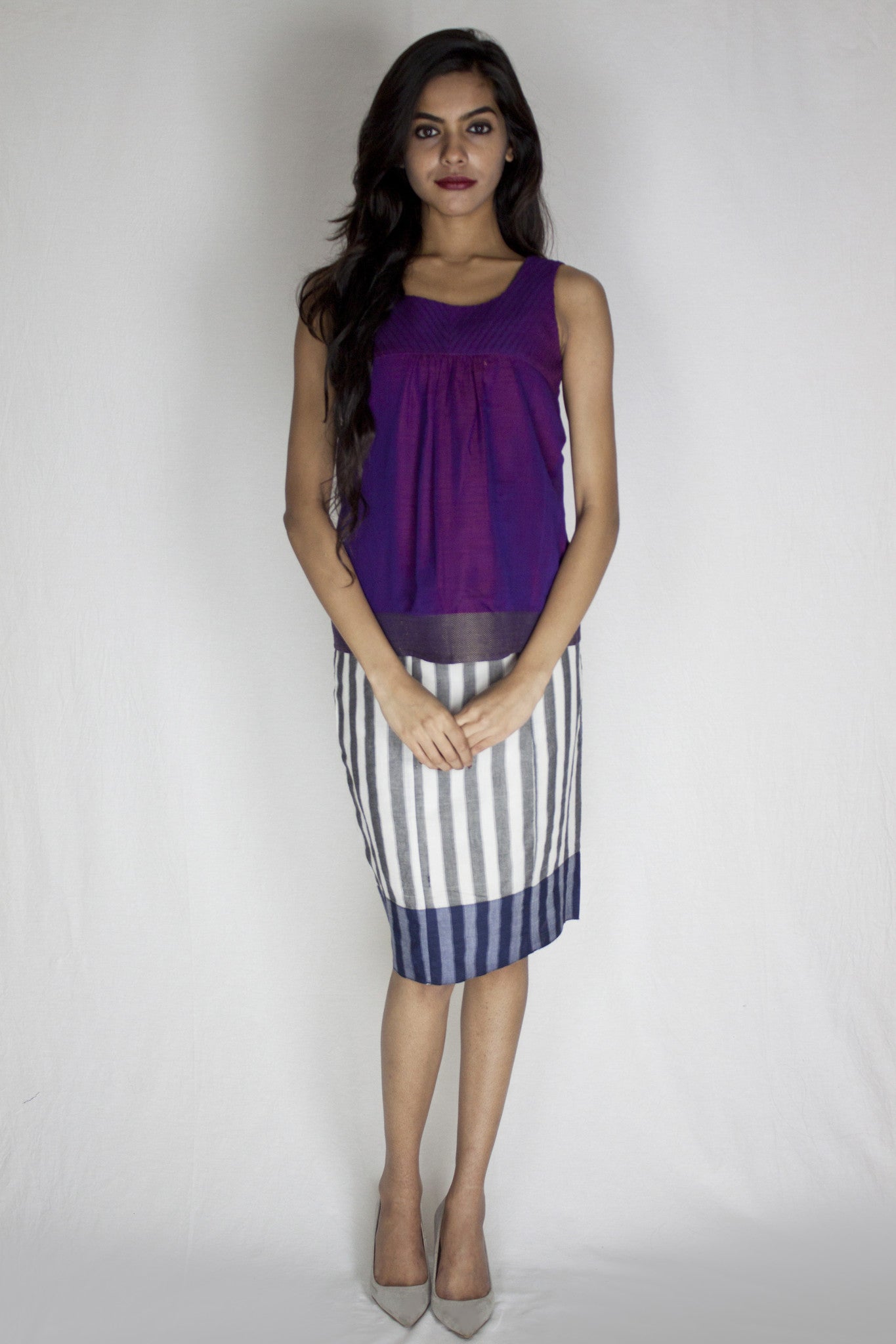 woman wearing purple top with striped skirt