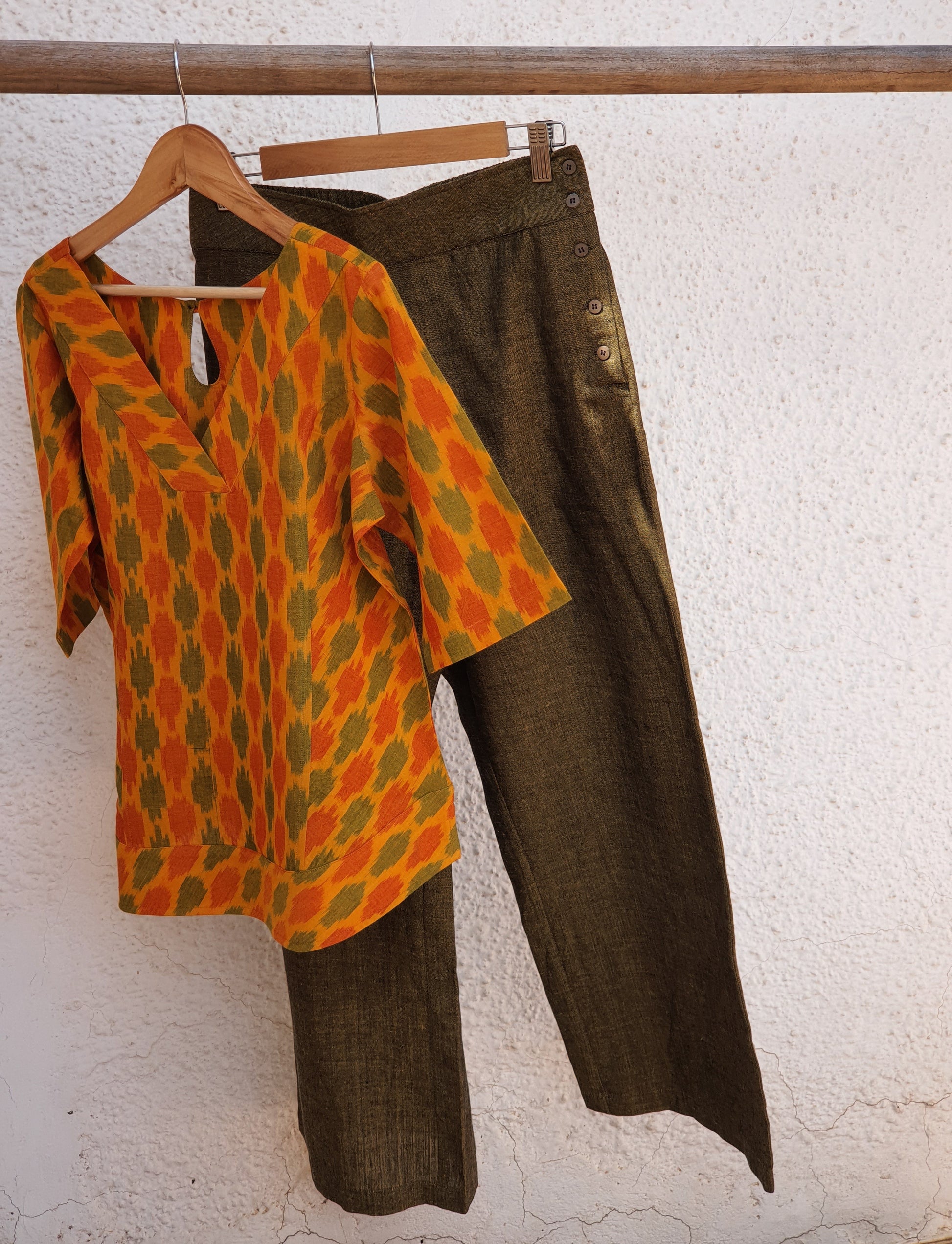 Image of V necked top in yellow geometric ikkat paired with olive pants 